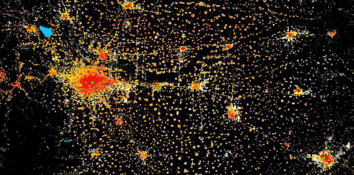 A satellite image with an imposition of Settlements and their growth over time from 1975, 1990, 2000, 2015 respectively colorcoded with red, orange, yellow, white.